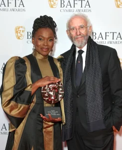 Rakie Ayola with Jonathan Pryce. Photo credit: Bafta Cymru. Dress by SABRIRAH